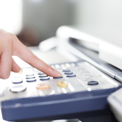girl's finger presses button of copier beautiful asian girl in white operating copier in modern office
